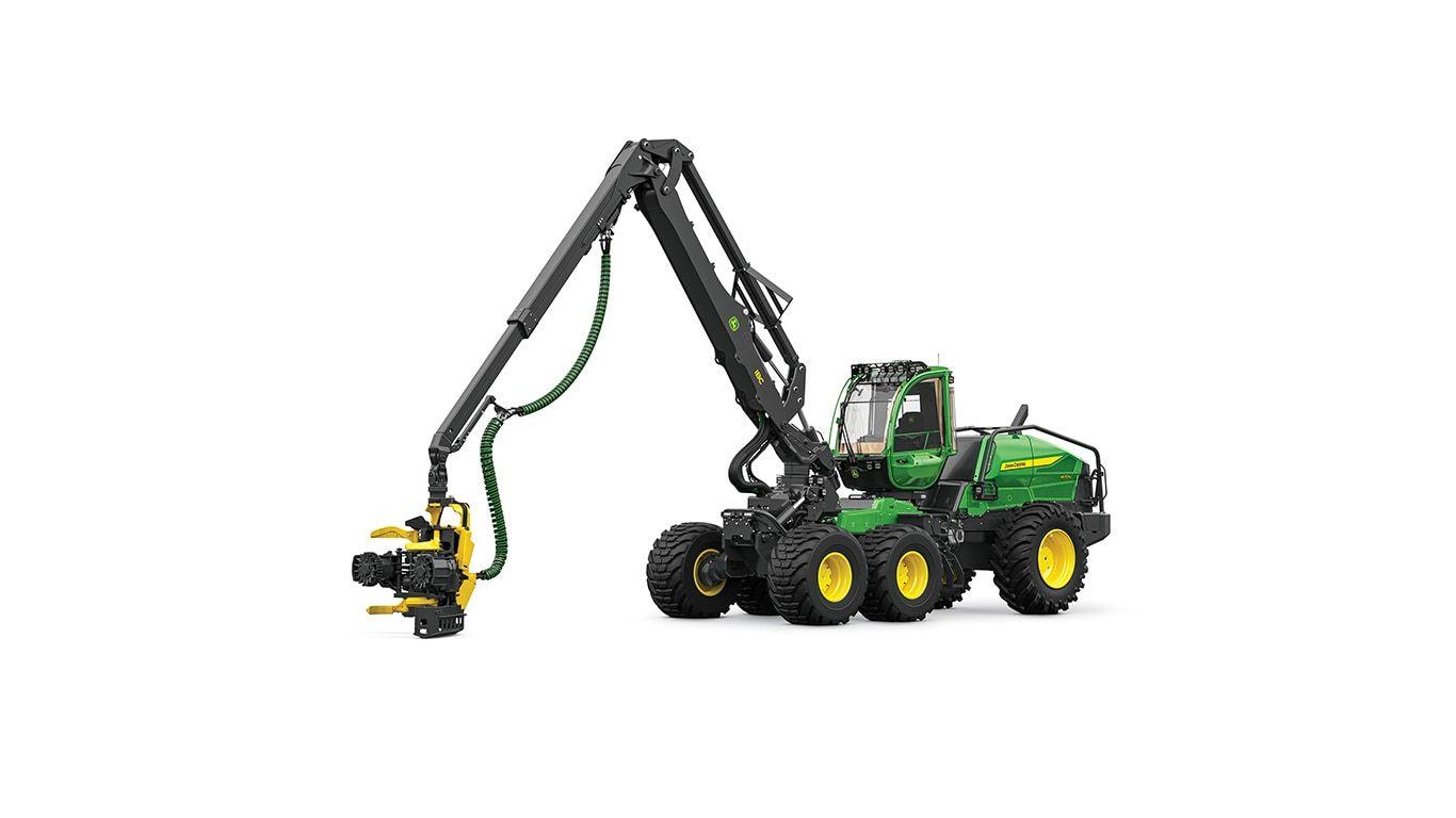 Green and yellow forestry machine with an extended arm holding a cutting attachment.