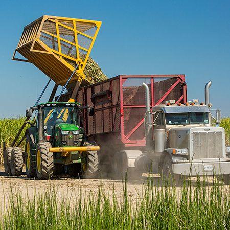 In-field equipment transloading into highway trucks
