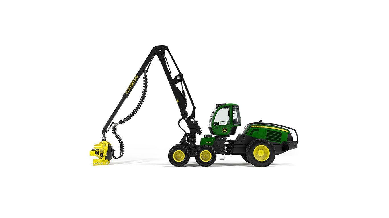 Green and yellow forestry machine with an extended arm holding a cutting attachment.
