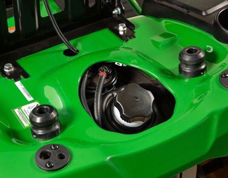 Seat raised for fuel-fill access showing rubber isolators
