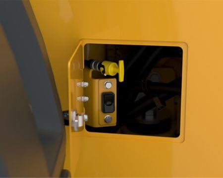 The engine oil dipstick is located near the back tire on the left side, giving operators easier access to perform daily service checks