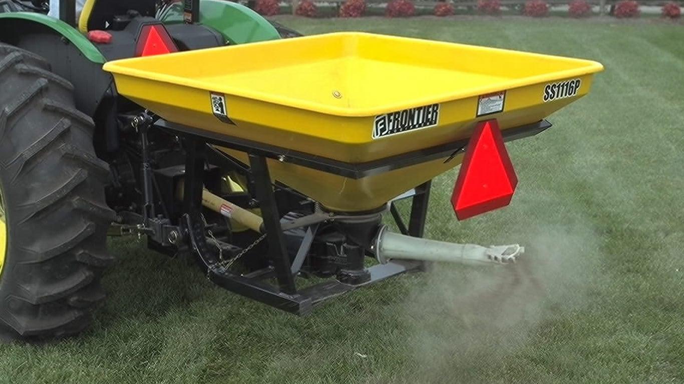 Field image of SS1116P pendular spreader attached to the rear of Tractor