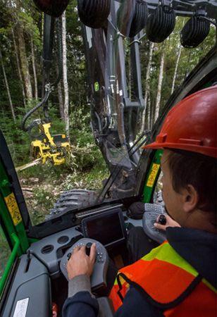 View out the front window of a wheeled harvester