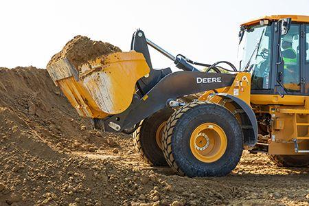Improved bucket rollback and material retention