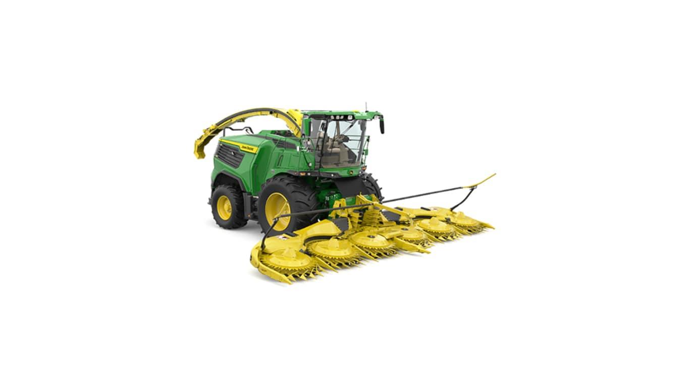 A front-right-facing green F9 700 self-propelled forage harvester with a yellow header on a white background.