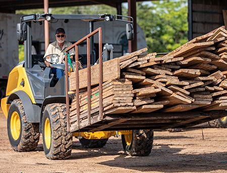 Loader moving material with forks