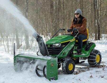 S140 Tractor with snow blower, weights, and tire chains